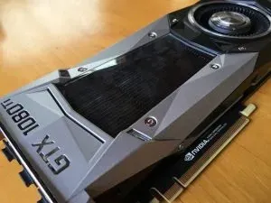 The card out of its box on a pale timber floor, GTX 1080 Ti lettering running along the angled shroud