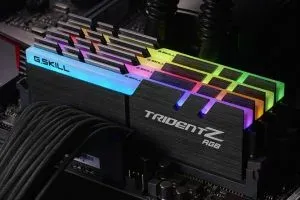 Four Trident Z RGB sticks seated in a board, their light bars lit across the full rainbow