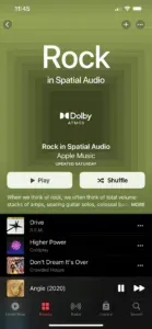 Apple Music's Rock in Spatial Audio playlist with a Dolby Atmos badge, over tracks by R.E.M., Coldplay and Crowded House