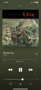 Apple Music playing All Over You by Live, Dolby Atmos marked beneath the scrubber