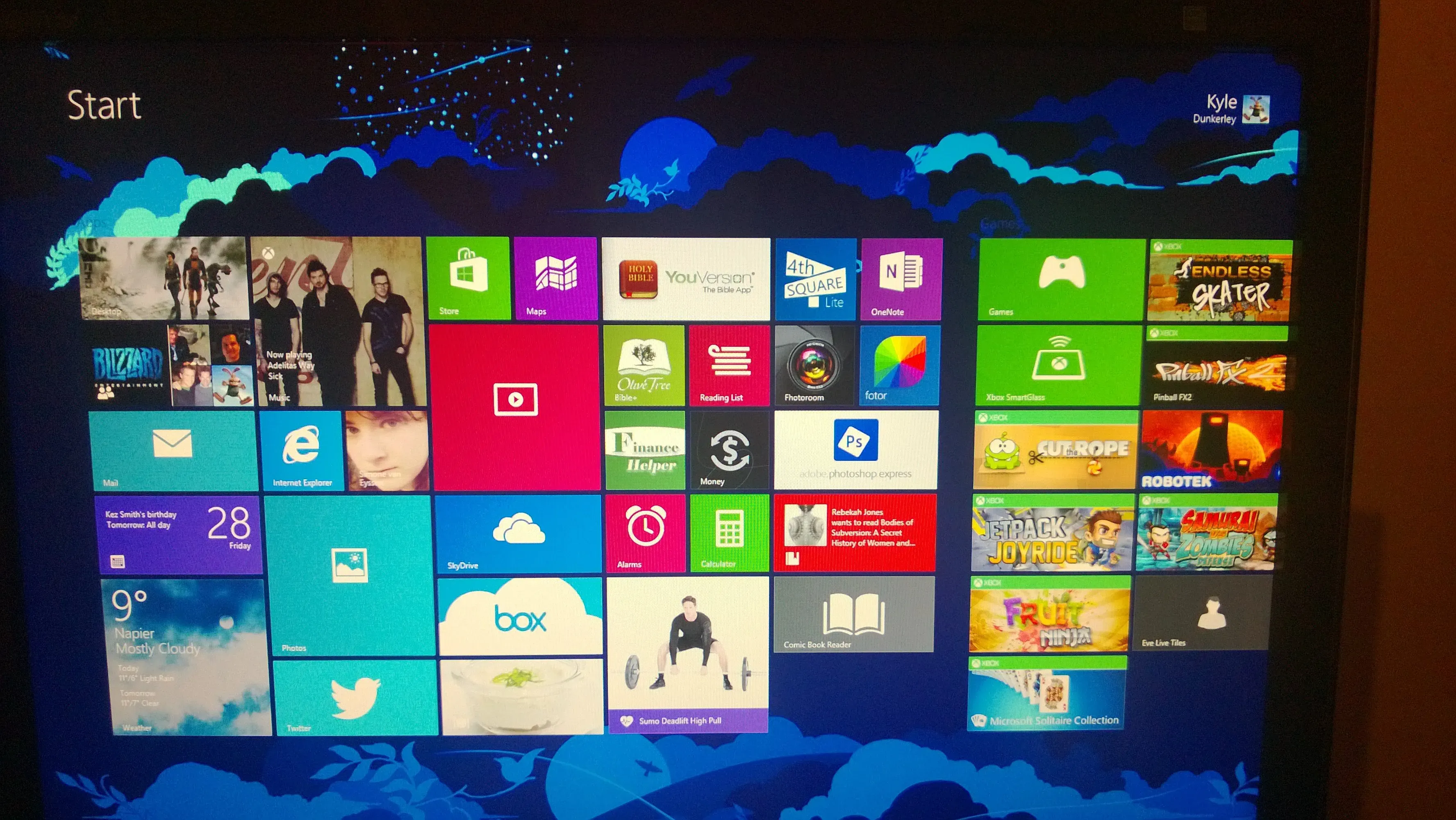 Windows 8.1 Start Screen packed edge to edge with live tiles for weather, music, mail and Xbox games