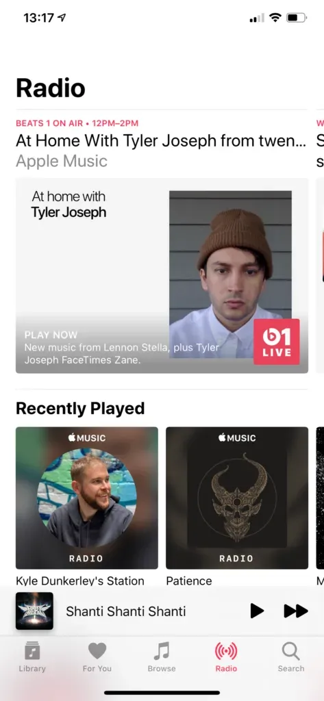 iPhone Radio tab showing Beats 1 on air with At Home With Tyler Joseph