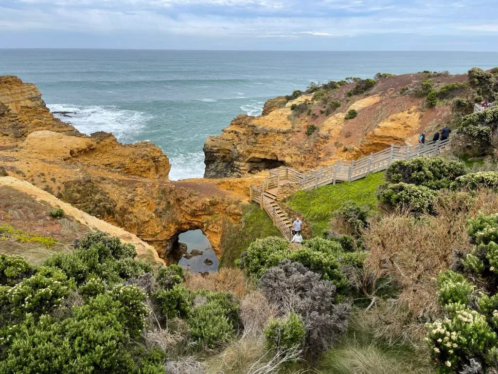 The arch and its pool from above, with the stairway and lookout cut into the headland
