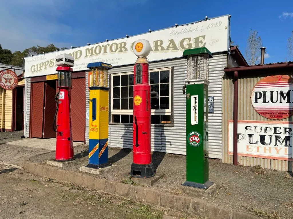 Four restored petrol bowsers - Plume, Golden Fleece, Shell and COR - outside the 1929 Gippsland Motor Garage